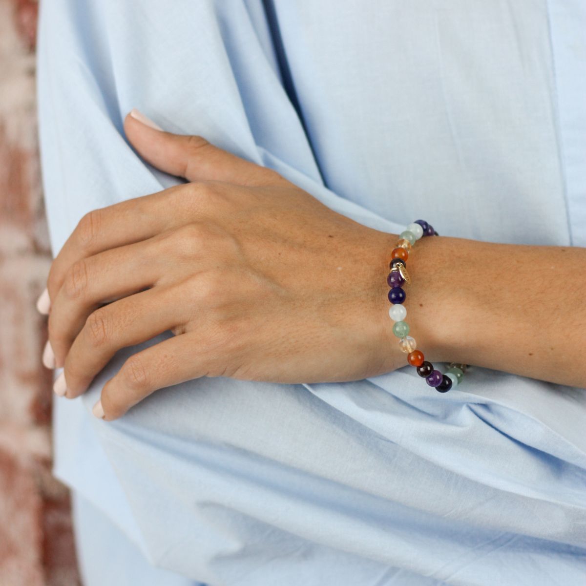 a woman wearing a bracelet on her wrist
