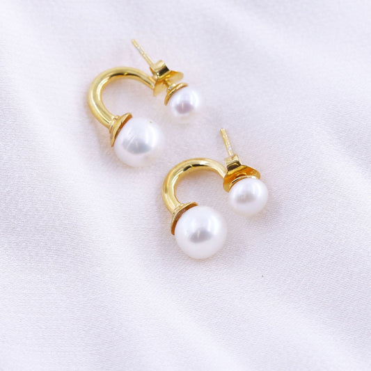 gold-plated half hoop double pearl earrings on a white background