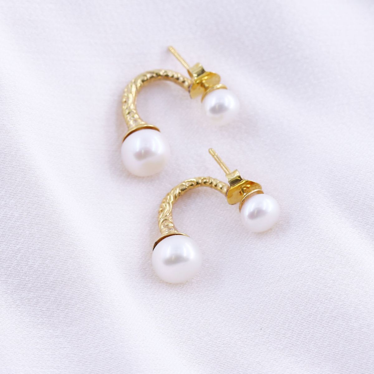 gold plated half hoop double pearl earrings on a white background