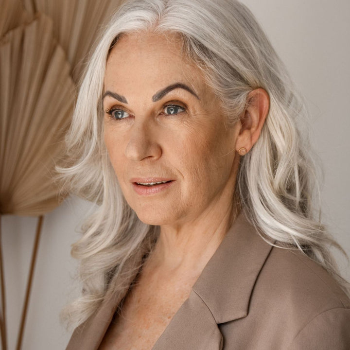 a woman wearing peach moonstone studs in her ears