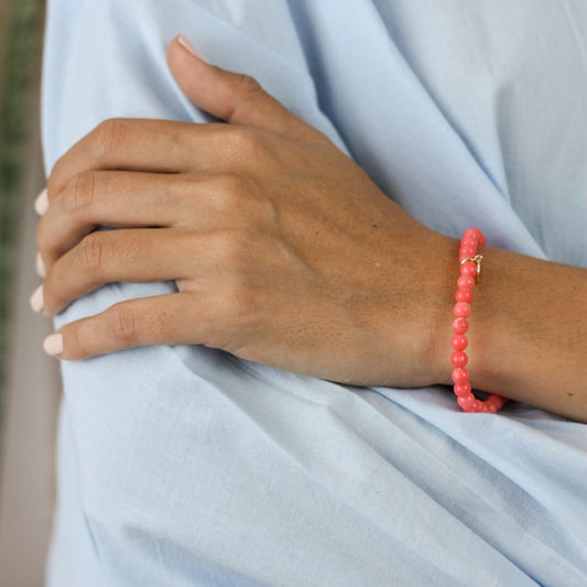 a woman wearing a stone bracelet on her wrist 